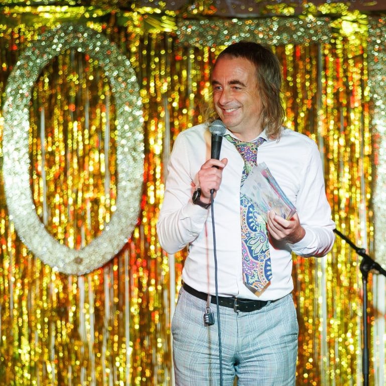 comedian Paul Foot doing a stand up routine on stage at the Moth club